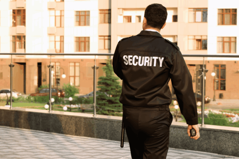 a security person standing outside with security uniform on
