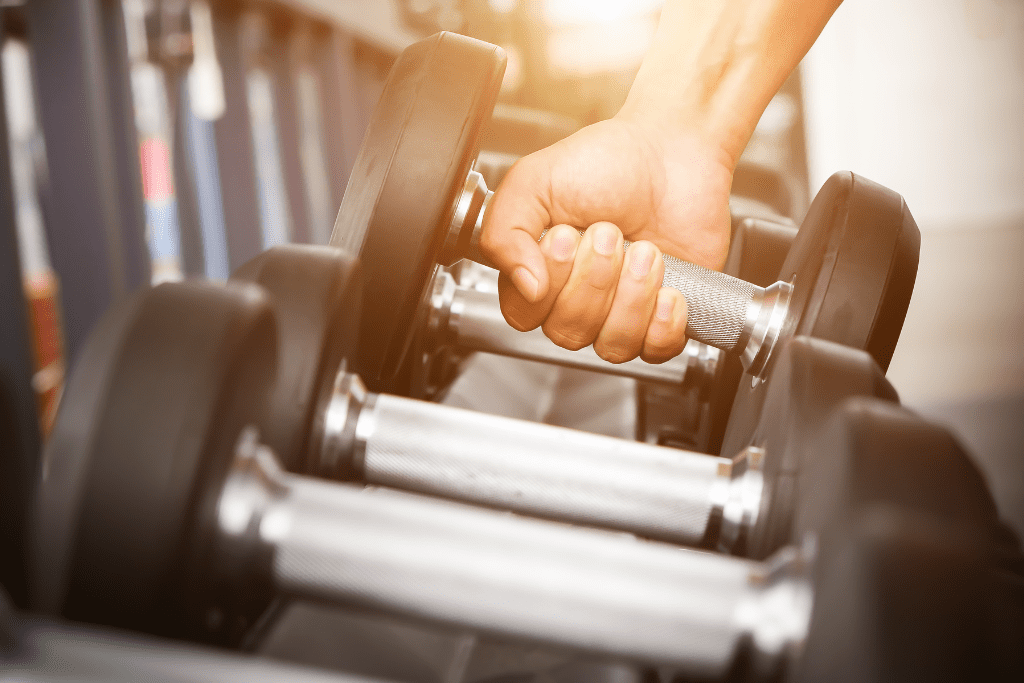 a hand lifting weights at a gym