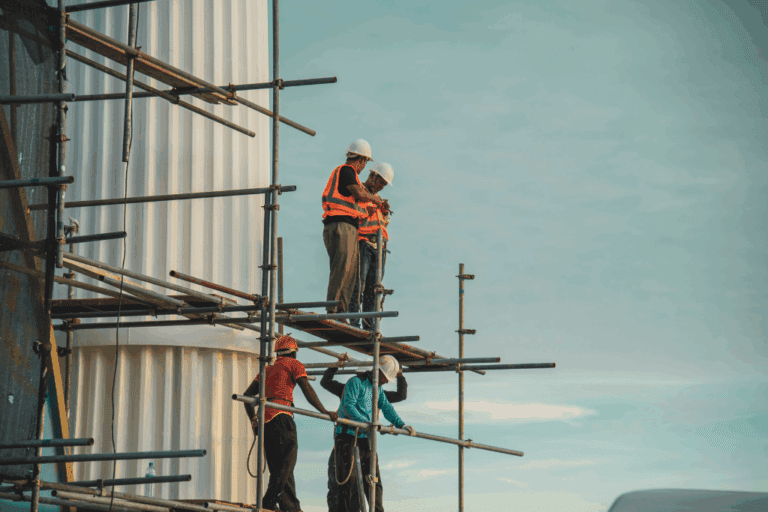 people standing on scaffolding on the side of a building
